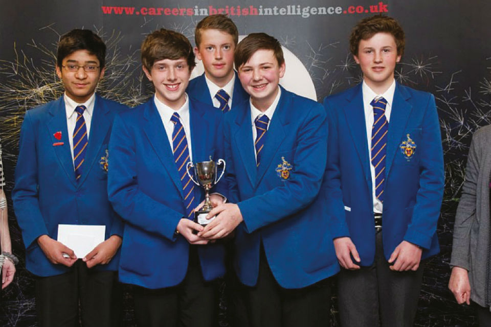 Photograph of school pupils holding a trophy.