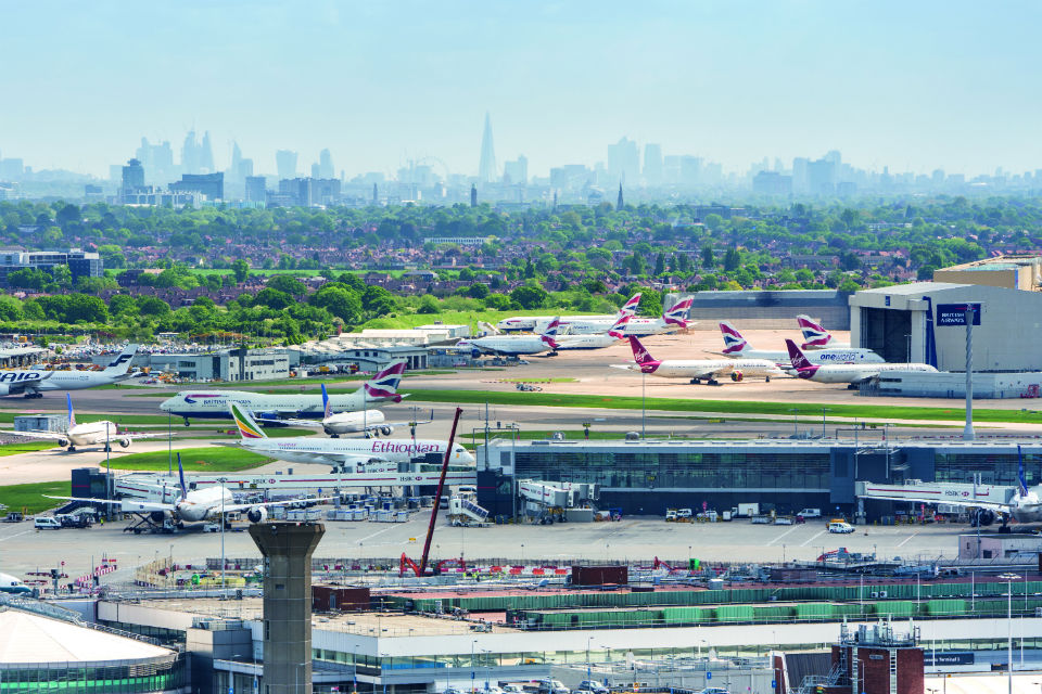 Birds-eye view of London Heathrow Airport, with London skyline in the distance