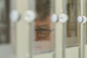 Partial reflection of Martin Parkinson in glass picture frames